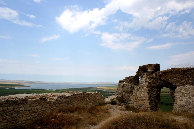 an ancient wall of brick with a beautiful scenery in the background