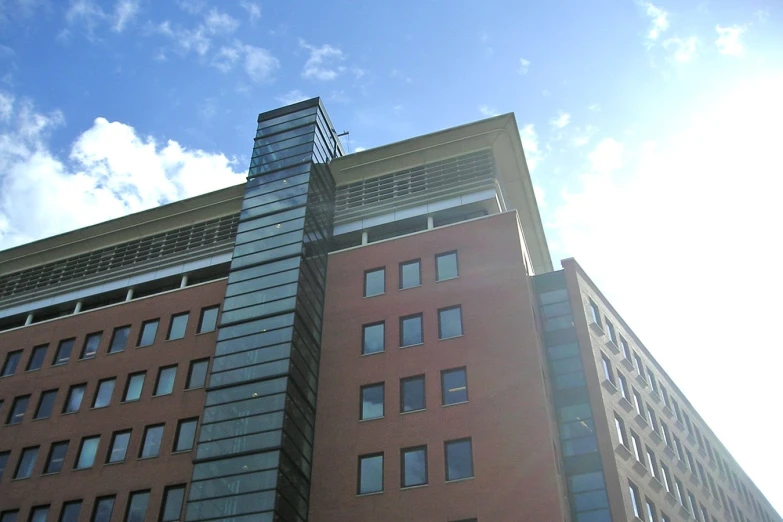 an image of a very tall brick building with a clock on the side