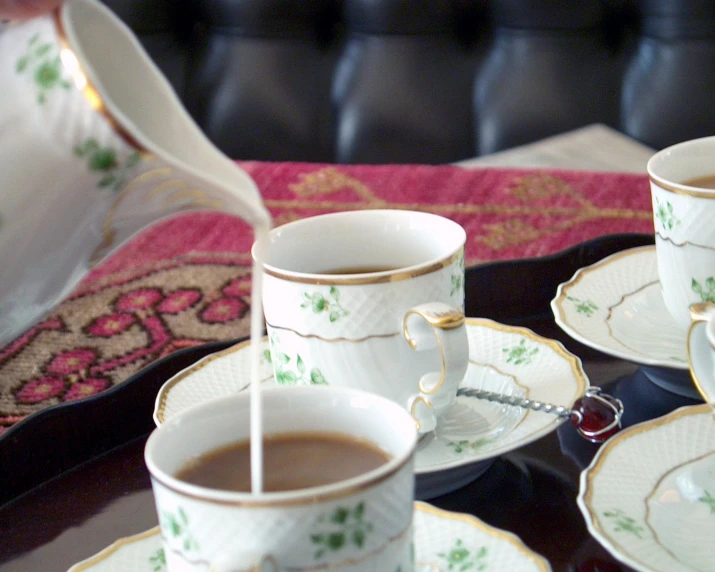 tea set with cups filled with  chocolate in decorative dishes