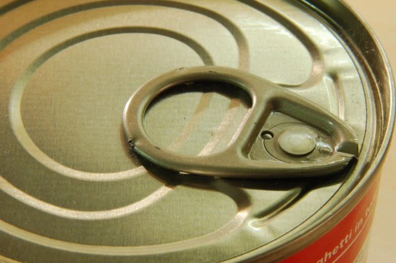 a close - up of a can with a pair of scissors