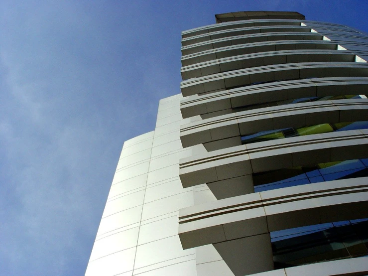 a high rise building in the daytime, looking up at it