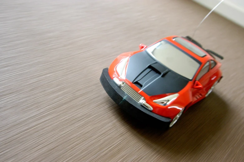 the toy car on the floor is red