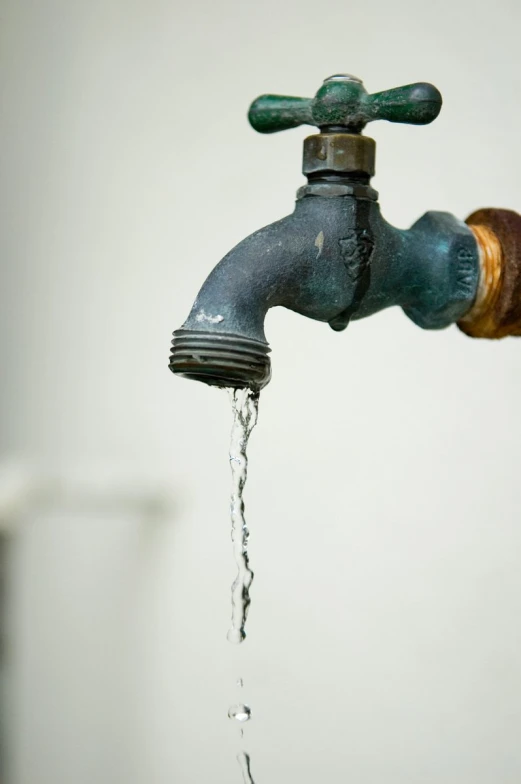 a faucet filled with water from a running spout