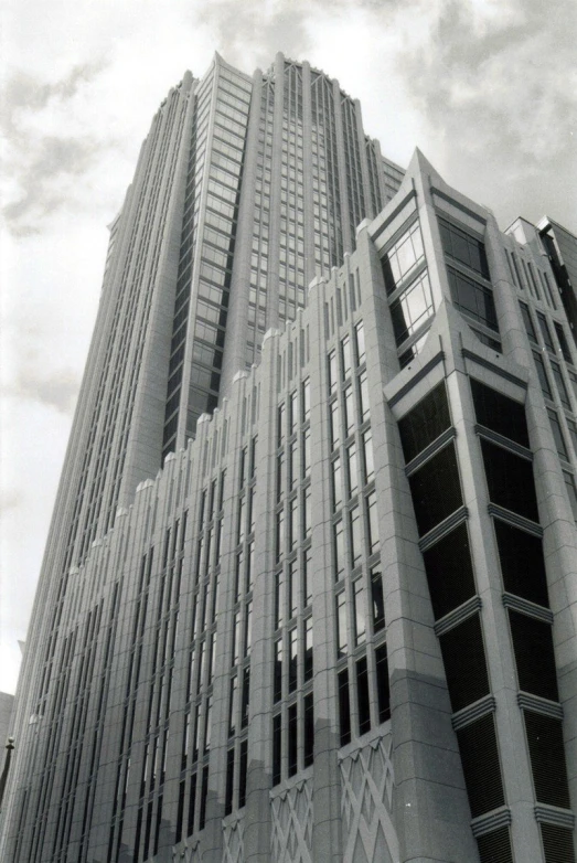 a tall building with windows and a sky background