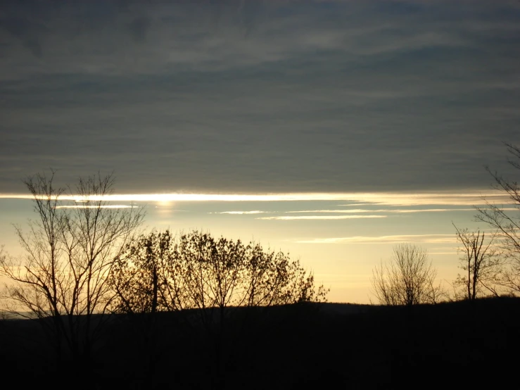 a sky filled with clouds and the sun shining