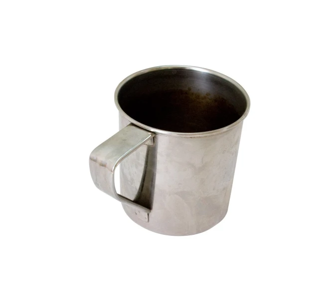 a cup with handles sitting on top of a white surface