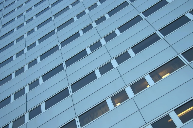 an abstract image of a tall building with multiple windows