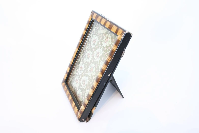 a large wooden mirror sitting on top of a white table