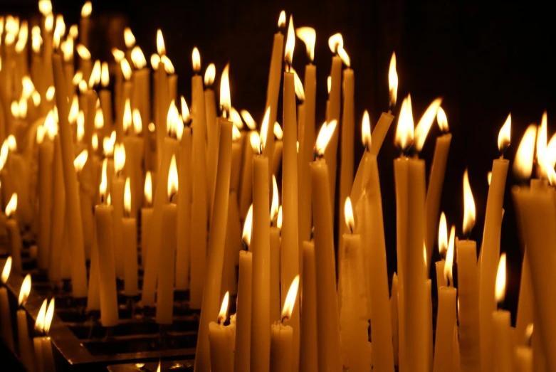 rows of candles with the ones white light