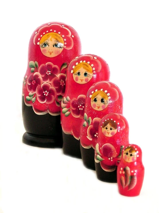 there are several red painted russian dolls on this stand