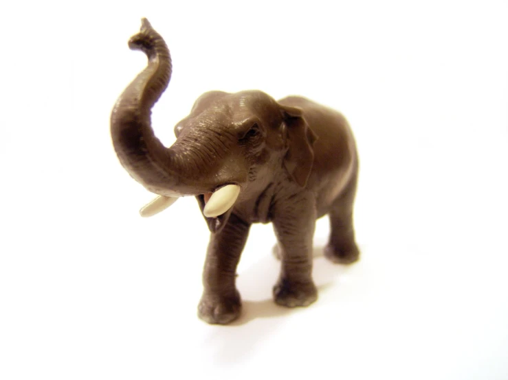 a little plastic elephant toy that is brown