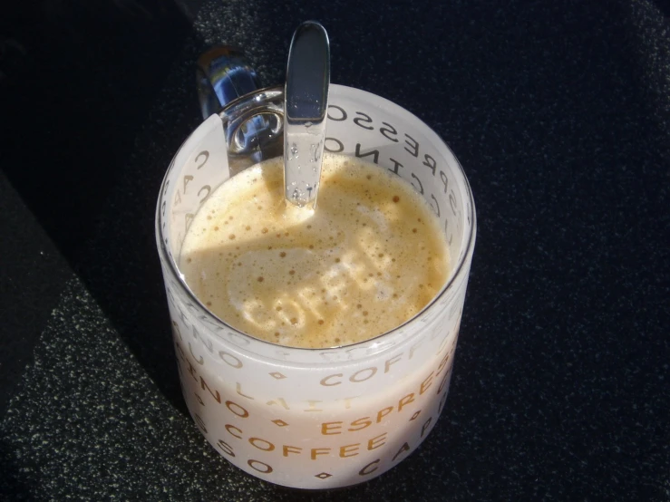 a cup of coffee with a spoon stuck in it
