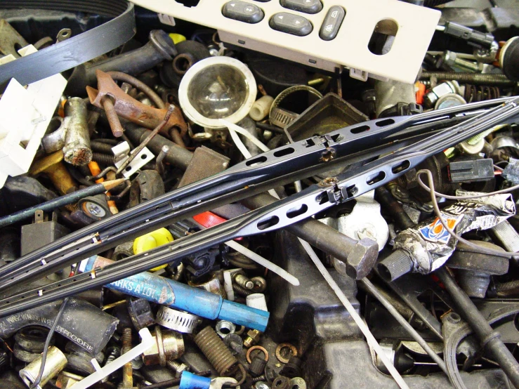 the front bumper and wiper covers on a pile of old junk