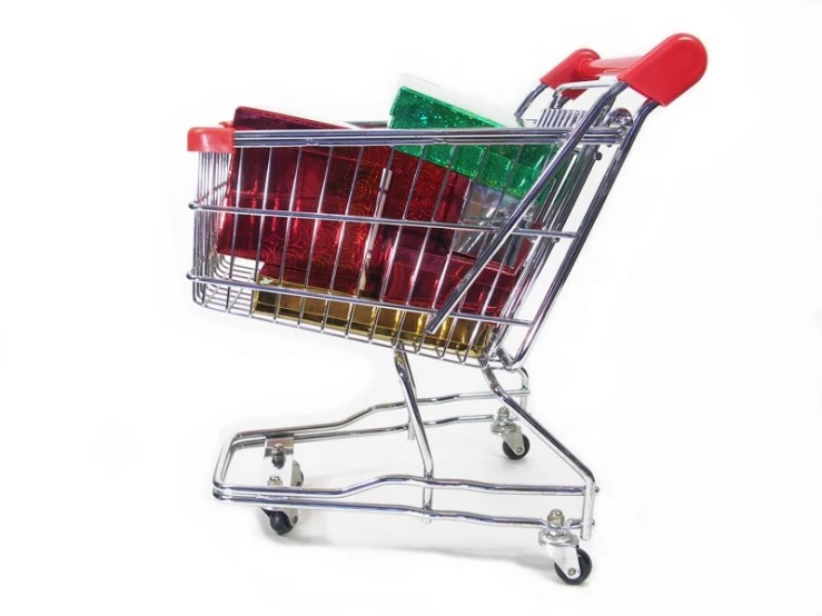 shopping cart full of christmas presents against white background