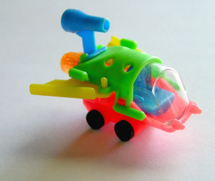 a green and red toy airplane with lots of different parts