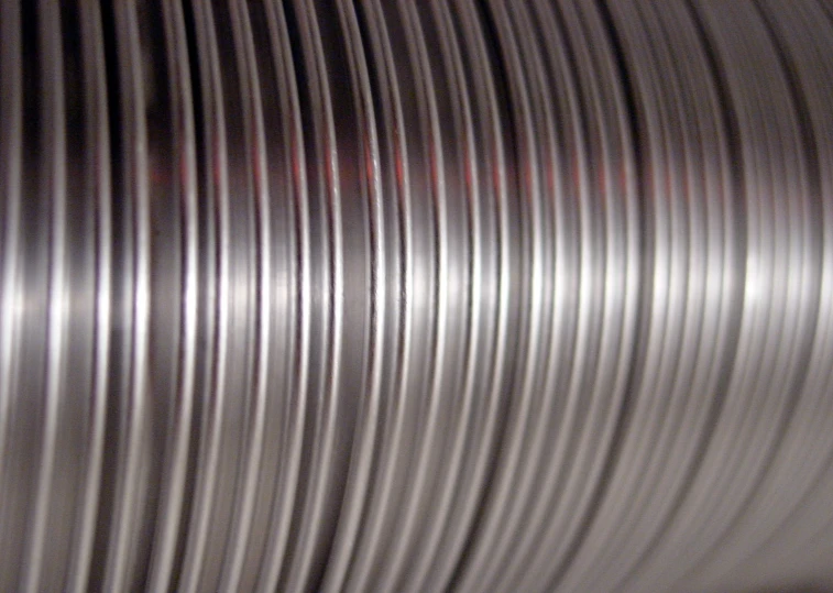 a spool of metal is seen on the side of a silver object