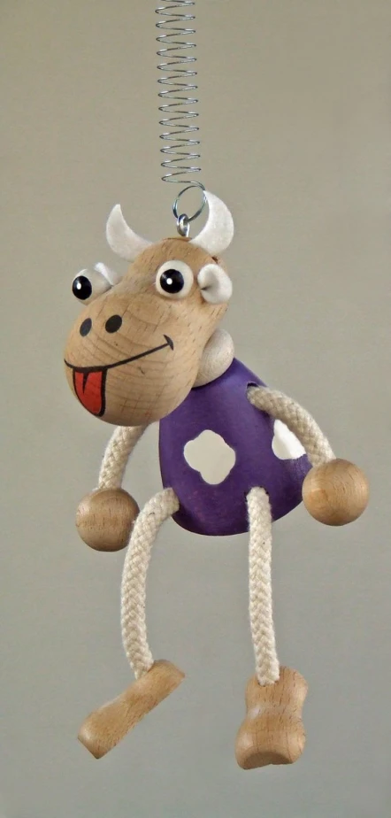 the baby toy has horns and a purple shirt