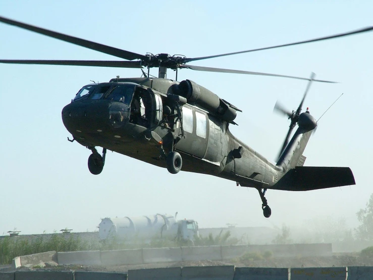 a helicopter flying over a freeway filled with trucks