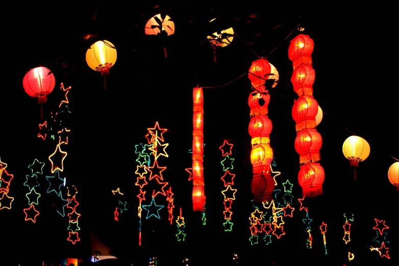 a group of lamps hanging on a building at night