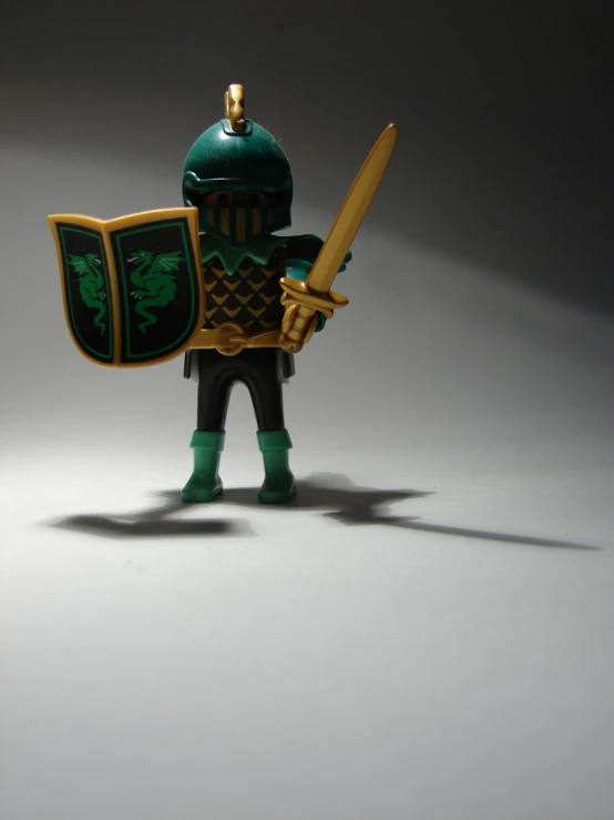 an image of a green and yellow mini figure holding a sword