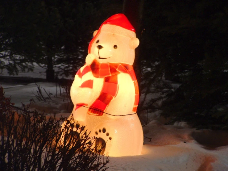 a very big frosty teddy bear in the snow