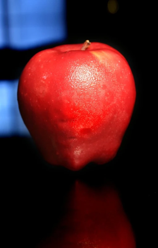 an apple with a blurry background and water