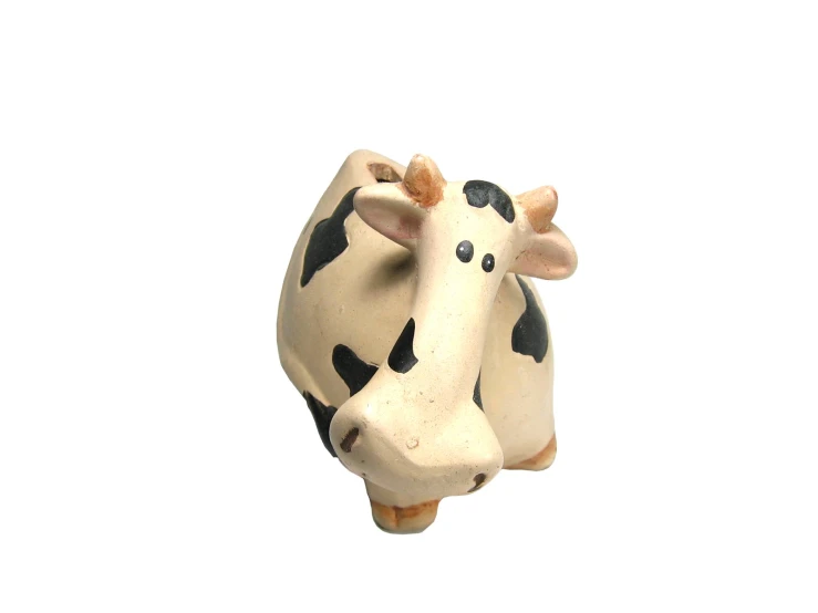 two ceramic cow sculptures are sitting together