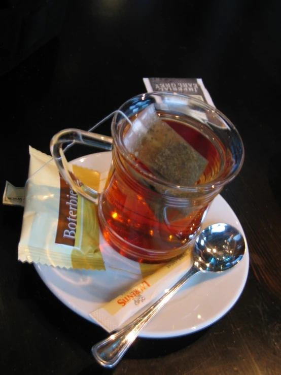 tea served in a teapot with powdered sugar, jelly and lemon slices