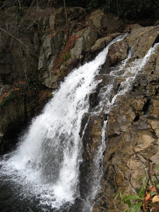 there is a large waterfall going down the side of the mountain