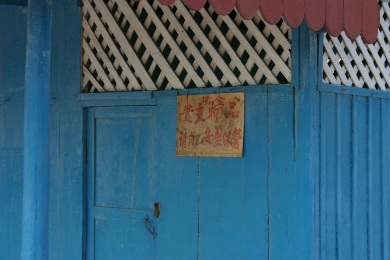 a blue door with a sign on it