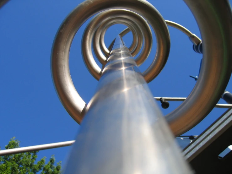 the outside of a metal structure looking upwards at it's spiral design