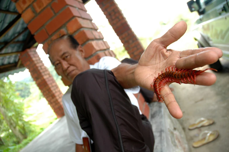 a man holding soing in his hands outside