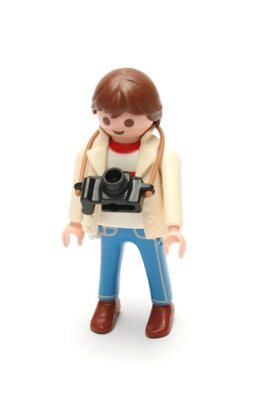 an action figure is holding a camera