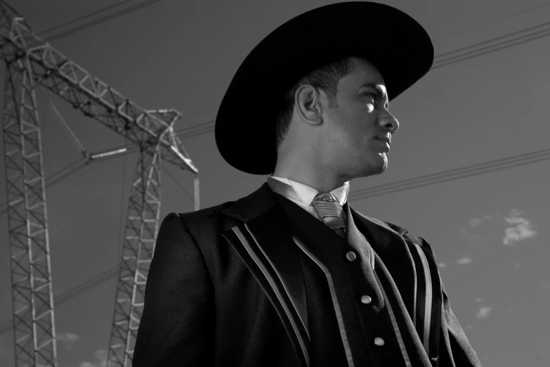 black and white pograph of a man in a suit, hat, and bowtie