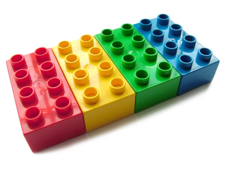 four lego blocks stacked together in different colors