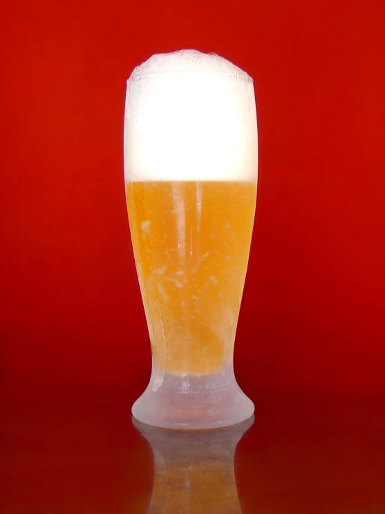 a close - up of a beer glass on a shiny surface