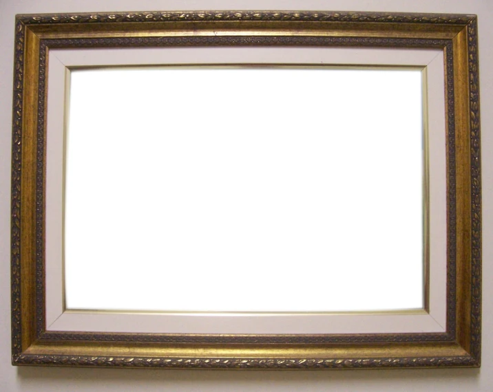 a rectangular gold frame in an empty room