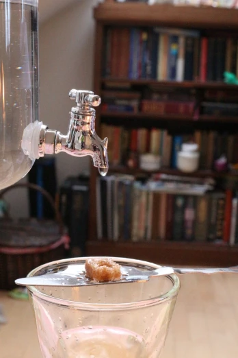a water pitcher and some food in a glass bowl