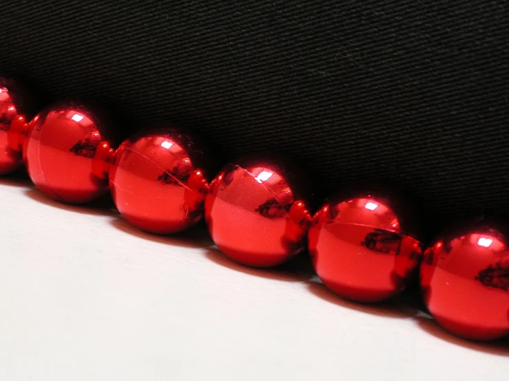 red and black balls are lined up on a table