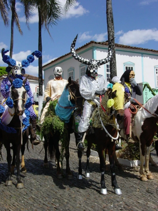a group of people dressed as mexican characters are riding horses