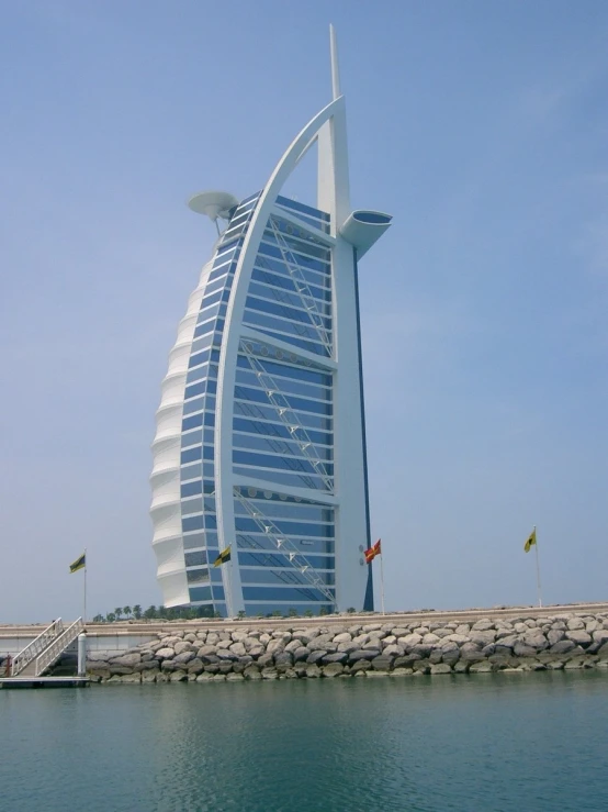 a tall sailboat sitting in the middle of the water