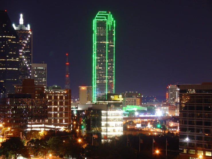 view of skyline with a large building lit up with christmas lights