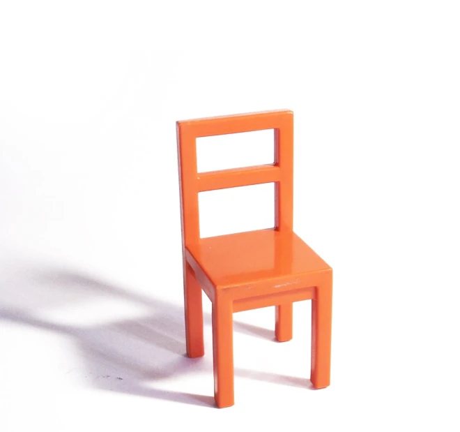 an orange plastic chair that is shaped like a reclining chair