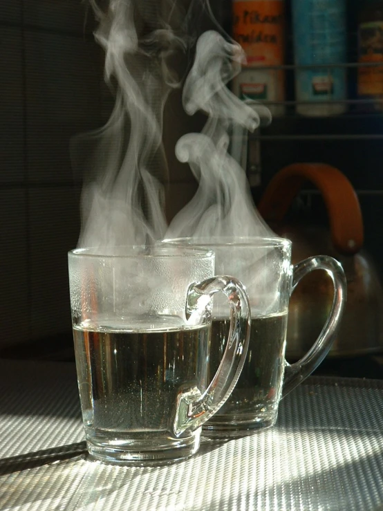 two coffee cups with steaming steam on the side