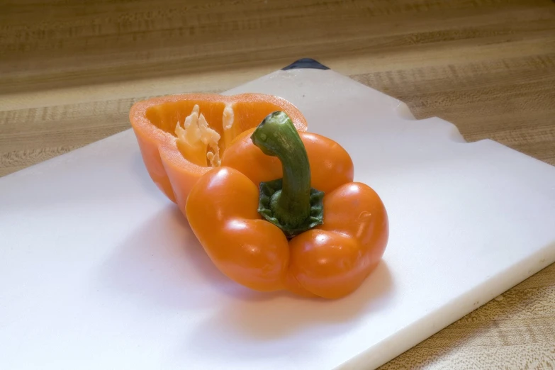 a peeled red bell pepper on top of a  board