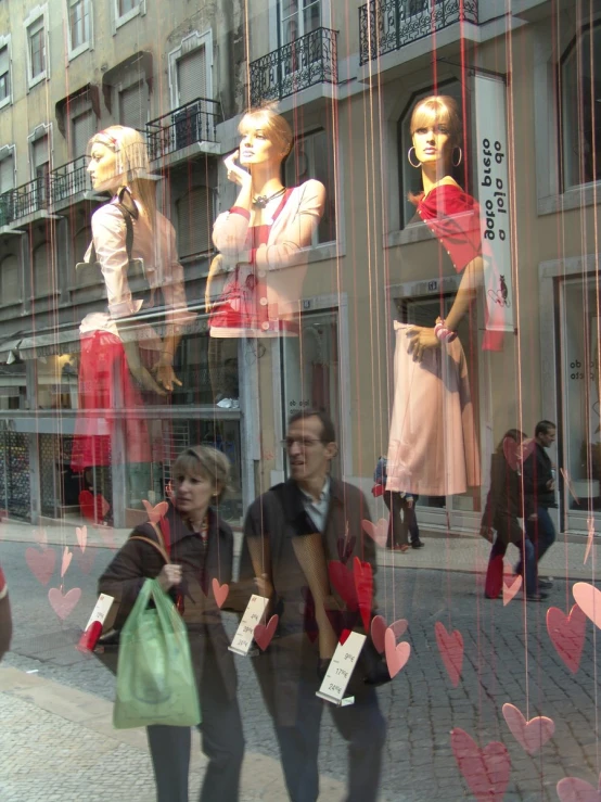 a couple of women looking through a window