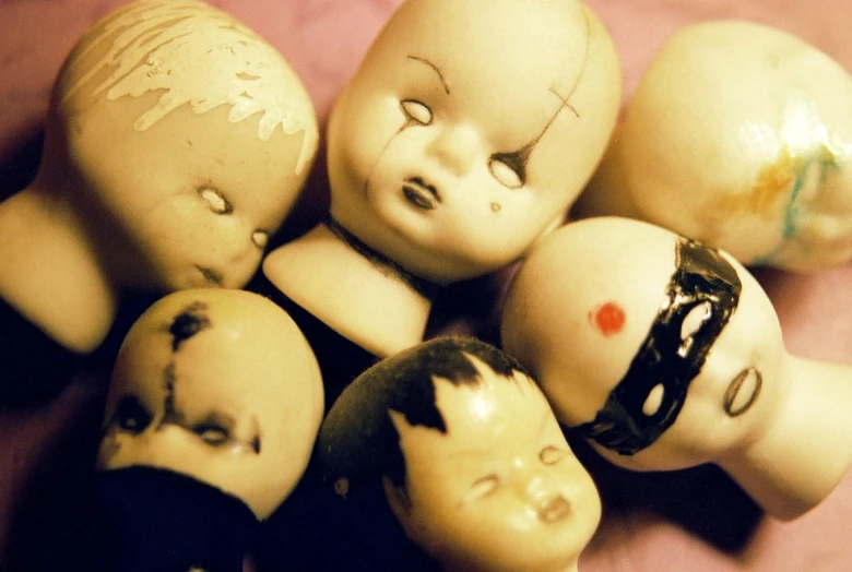 an arrangement of dolls made up of various heads
