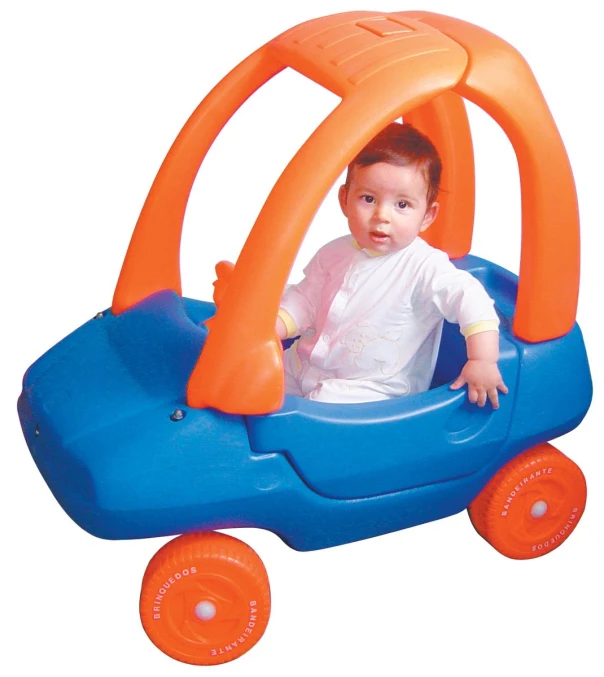 an infant in a blue toy car with orange wheels