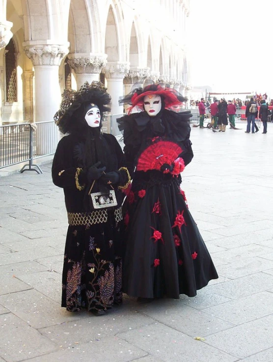 two woman with painted faces posing together on the street