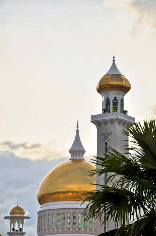 a white and gold domed building with a gold dome on top